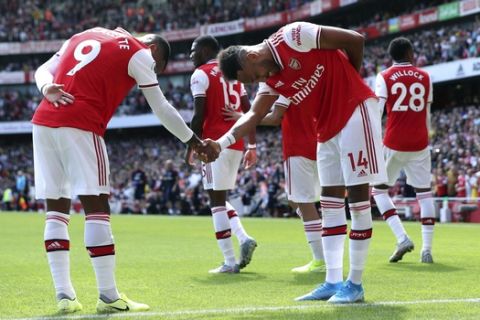 Arsenal's Pierre-Emerick Aubameyang, right, celebrates with teammates after scoring his side's first goal of the game, during the English Premier League soccer match between Arsenal and Burnley FC, at The Emirates Stadium, in London, Saturday, Aug. 17, 2019. (Yui Mok/PA via AP)