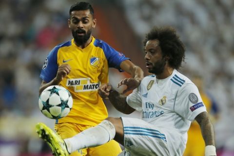 Real Madrid's Marcelo, right, and APOEL Nicosia's Ghayas Zahid battle for the ball during a Champions League group H soccer match between Real Madrid and Apoel Nicosia at the Santiago Bernabeu stadium in Madrid, Spain, Wednesday, Sept. 13, 2017. (AP Photo/Paul White)