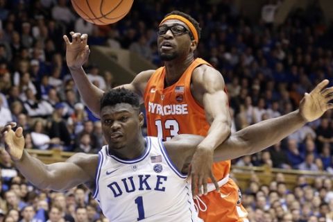Duke's Zion Williamson (1) and Syracuse's Paschal Chukwu (13) struggle for possession during overtime in an NCAA college basketball game in Durham, N.C., Monday, Jan. 14, 2019. Syracuse won 95-91. (AP Photo/Gerry Broome)