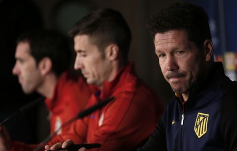 Atletico Madrid head coach Diego Simeone, right, Diego Godin, left, and Gabriel Fernandez "Gabi" arrive to a news conference at the Santiago Bernabeu stadium in Madrid, Monday, May 1, 2017. Atletico Madrid will play a Champions League first leg semifinal soccer match against Real Madrid on Tuesday 2. (AP Photo/Francisco Seco)
