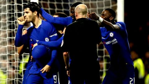 Chelsea's Alvaro Morata, left celebrates with his teammates after scoring his sides second goal of the game during the English League Cup quarterfinal soccer match between Chelsea and Bournemouth at Stamford Bridge stadium in London, Wednesday, Dec. 20, 2017. Chelsea won the game 2-1. (AP Photo/Alastair Grant)
