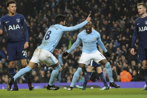 Manchester City's Ilkay Gundogan, centre, celebrates after scoring his side's first goal during the English Premier League soccer match between Manchester City and Tottenham Hotspur at Etihad stadium, in Manchester, England, Saturday, Dec. 16, 2017. (AP Photo/Rui Vieira)