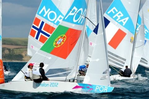 Portugese sailors Afonso Domingos and Frederico Melo round the mark with other crews in the Star sailing class practice race for the London 2012 Olympic Games, in Weymouth on July 28, 2012.  AFP PHOTO/William WEST        (Photo credit should read WILLIAM WEST/AFP/GettyImages)