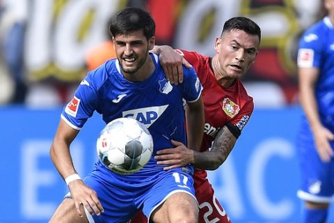 Leverkusen's Charles Aranguiz, right, and Hoffenheim's Florian Grillitsch challenge for the ball during the German Bundesliga soccer match between Bayer Leverkusen and TSG 1899 Hoffenheim in Leverkusen, Germany, Saturday, Aug. 31, 2019. The match ended 0-0. (AP Photo/Martin Meissner)
