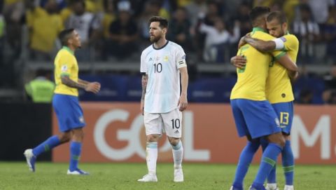 Argentina's Lionel Messi, center, reacts after losing to Brazil during a Copa America semifinal soccer match at the Mineirao stadium in Belo Horizonte, Brazil, Tuesday, July 2, 2019. Brazil defeated Argentina 2-0 and advances to the final. (AP Photo/Natacha Pisarenko)