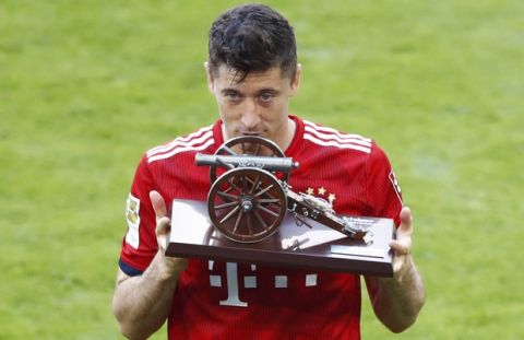 Bayern's Robert Lewandowski shows the trophy as best scorer after the German Soccer Bundesliga match between FC Bayern Munich and VfB Stuttgart in Munich, Germany, Saturday, May 12, 2018. (AP Photo/Matthias Schrader)