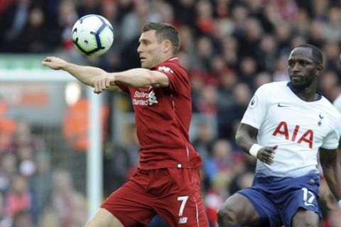Liverpool's James Milner, left, duels for the ball with Tottenham's Moussa Sissoko during the English Premier League soccer match between Liverpool and Tottenham Hotspur at Anfield stadium in Liverpool, England, Sunday, March 31, 2019. (AP Photo/Rui Vieira)