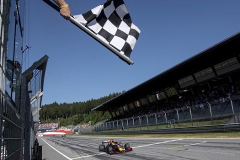Red Bull driver Max Verstappen of the Netherlands crosses the finish line to win the Austrian Formula One Grand Prix at the Red Bull Ring racetrack in Spielberg, southern Austria, Sunday, June 30, 2019. (Christian Bruna, Pool via AP)