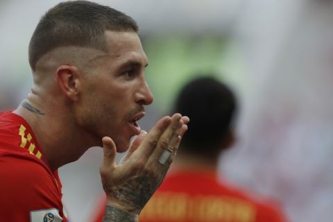 Spain's Sergio Ramos blows a kiss as he celebrates after Spain score the opening goal of the game after Russia's Sergei Ignashevich scored an own goal during the round of 16 match between Spain and Russia at the 2018 soccer World Cup at the Luzhniki Stadium in Moscow, Russia, Sunday, July 1, 2018. (AP Photo/Manu Fernandez)