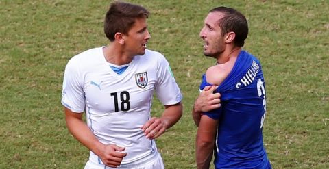 NATAL, BRAZIL - JUNE 24:  Giorgio Chiellini of Italy pulls down his shirt after a clash with Luis Suarez of Uruguay (not pictured) as Gaston Ramirez of Uruguay looks on during the 2014 FIFA World Cup Brazil Group D match between Italy and Uruguay at Estadio das Dunas on June 24, 2014 in Natal, Brazil.  (Photo by Julian Finney/Getty Images)