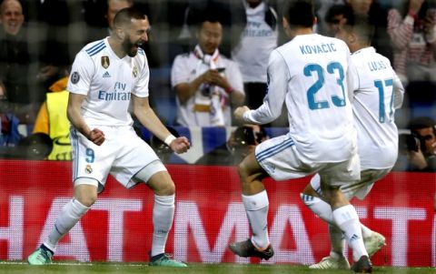 Real Madrid's Karim Benzema, left, celebrates with team mates Mateo Kovacic and Lucas Vazquez after scoring his side's second goal during the Champions League semifinal second leg soccer match between Real Madrid and FC Bayern Munich at the Santiago Bernabeu stadium in Madrid, Spain, Tuesday, May 1, 2018. (AP Photo/Francisco Seco)