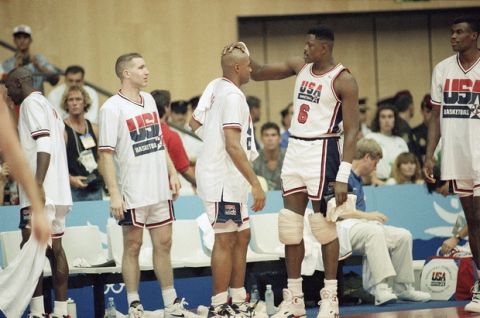 The USA's Patrick Ewing, right. Congratulates teammate Charles Barkley near the end of their semifinal game with Lithuania at the XXV Summer Olympics in Barcelona, Thursday, August 6, 1992. At left is Chris Mullin. The USA beat Lithuania 127-76. (AP Photo/Susan Ragan)