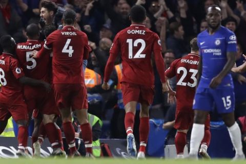 Liverpool players celebrate scoring the equalizer during the English Premier League soccer match between Chelsea and Liverpool which ended in a 1-1 draw at Stamford Bridge stadium in London, Saturday, Sept. 29, 2018. (AP Photo/Kirsty Wigglesworth)