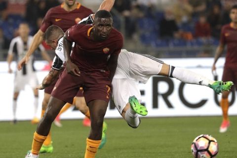 Juventus' Stefano Sturaro is airborne as he challenges Roma's Antonio Rudiger during a Serie A soccer match between Roma and Juventus, at Rome's Olympic stadium, Sunday, May 14, 2017. (AP Photo/Gregorio Borgia)