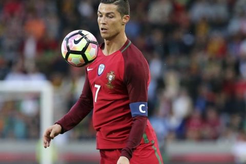 In this photo taken on Tuesday, March 28 2017, Portugal's Cristiano Ronaldo controls the ball during the international friendly soccer match between Portugal and Sweden at the dos Barreiros stadium in Funchal, Madeira island, Portugal. (AP Photo/Armando Franca)