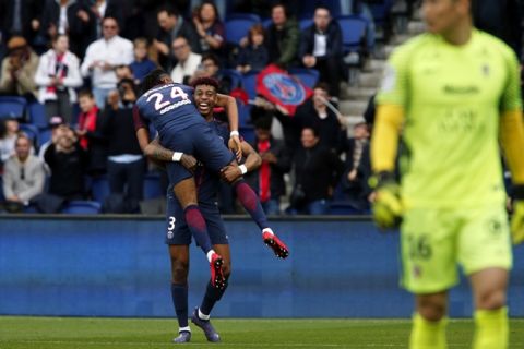 PSG's Christopher Nkunku, foreground, celebrates with teammate Presnel Kimpembe after scoring his side's second goal during the French League One soccer match between Paris Saint-Germain and Metz at the Parc des Princes Stadium, in Paris, France, Saturday, March 10, 2018. (AP Photo/Thibault Camus)