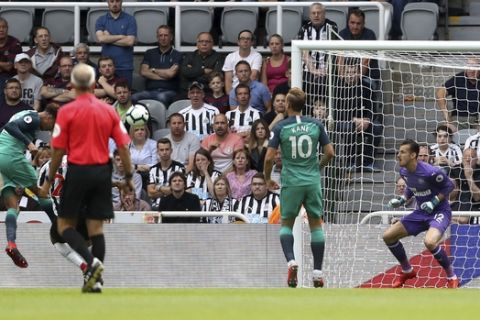 Tottenham's Dele Alli, left, scores his side's second goal of the game against Newcastle during their English Premier League soccer match at St James' Park in Newcastle, England, Saturday Aug. 11, 2018. (Owen Humphreys/PA via AP)