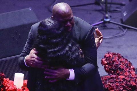 Former Los Angeles Lakers' Magic Johnson hugs Pam Bryant mother of Kobe Bryant during a celebration of life for Kobe Bryant and his daughter Gianna Monday, Feb. 24, 2020, in Los Angeles. (AP Photo/Marcio Jose Sanchez)