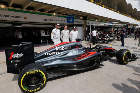 McLaren driver Jenson Button of Britain, from left center, McLaren test and reserve driver Stoffel Vandoorne of Belgium, and McLaren driver Fernando Alonso of Spain, pose for a photo  at the Interlagos race track in Sao Paulo, Brazil, Thursday, Nov. 12, 2015. Alonso, and Button will compete Sunday in the Brazilian Formula One Grand Prix at Sao Paulo's Interlagos circuit. (AP Photo/Silvia Izquierdo)