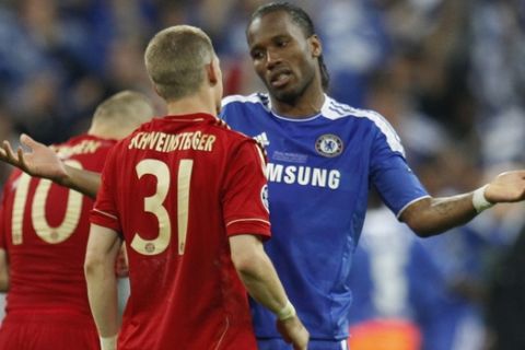 Chelsea's Didier Drogba, right, talks to Bayern's Bastian Schweinsteiger during the Champions League final soccer match between Bayern Munich and Chelsea in Munich, Germany Saturday May 19, 2012. (AP Photo/Matthias Schrader)