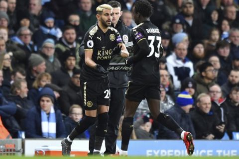 Leicester City's Riyad Mahrez, left, comes on to the pitch replacing Fousseni Diabate during the English Premier League soccer match between Manchester City and Leicester City the Etihad Stadium, Manchester, England. Saturday Feb. 10, 2018. (Anthony Devlin/PA via AP)
