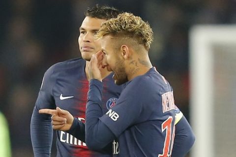 PSG's Marquinhos, left, talks with PSG's Neymar, right, and PSG's Thiago Thiago Silva during the French League One soccer match between Paris-Saint-Germain and Lyon at the Parc des Princes stadium in Paris, France, Sunday, Oct. 7, 2018. (AP Photo/Michel Euler)