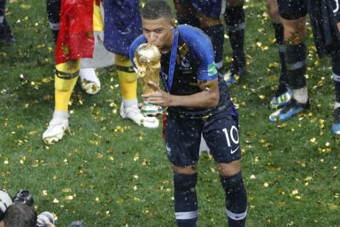 France's Kylian Mbappe kisses the trophy after the final match between France and Croatia at the 2018 soccer World Cup in the Luzhniki Stadium in Moscow, Russia, Sunday, July 15, 2018. (AP Photo/Frank Augstein)