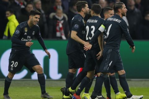 Real midfielder Marco Asensio, left, celebrates after scoring his side's second goal during the first leg, round of sixteen, Champions League soccer match between Ajax and Real Madrid at the Johan Cruyff ArenA in Amsterdam, Netherlands, Wednesday Feb. 13, 2019. (AP Photo/Peter Dejong)