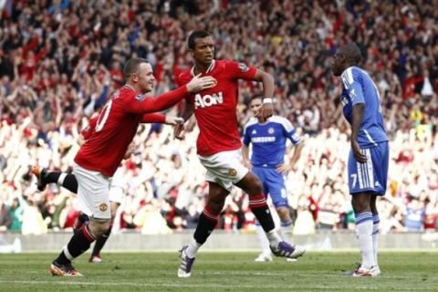 Manchester United's Nani, third right, is congratulated by team mate Wayne Rooney after scoring a goal against Chelsea during their English Premier League soccer match at Old Trafford, Manchester, England, Sunday Sept. 18, 2011. (AP Photo/Jon Super)