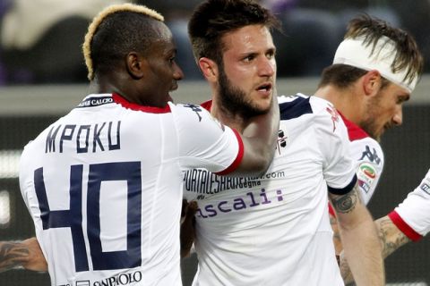 Cagliari forward Duje Cop, right, celebrates with his teammate Paul Jose M'Poku after scoring during a Serie A soccer match against Fiorentina at the Artemio Franchi stadium in Florence, Italy, Sunday, April 26, 2015. (AP Photo/Fabrizio Giovannozzi) 