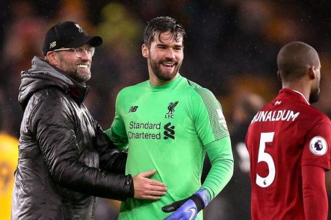 Wolverhampton Wanderers v Liverpool - Premier League - Molineux Liverpool manager Jurgen Klopp (left) goalkeeper Alisson Becker and Georginio Wijnaldum celebrate after the final whistle EDITORIAL USE ONLY No use with unauthorised audio, video, data, fixture lists, club/league logos or live services. Online in-match use limited to 120 images, no video emulation. No use in betting, games or single club/league/player publications. PUBLICATIONxINxGERxSUIxAUTxONLY Copyright: xNigelxFrenchx 40326300
