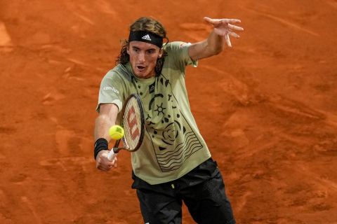 Greece's Stefanos Tsitsipas returns the ball against Andrei Rubliov during their match at the Mutua Madrid Open tennis tournament in Madrid, Spain, Friday, May 6, 2022. (AP Photo/Manu Fernandez)