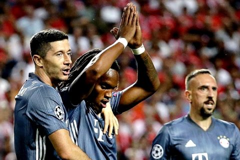 Bayern midfielder Renato Sanches, center, and Bayern forward Robert Lewandowski, left, celebrate their side's second goal during the Champions League group E soccer match between Benfica and Bayern Munich at the Luz stadium in Lisbon, Wednesday, Sept. 19, 2018. (AP Photo/Armando Franca)