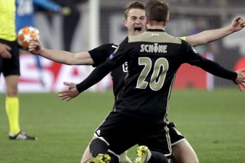 Ajax's Matthijs de Ligt and Lasse Schone celebrate at the end of the Champions League, quarterfinal, second leg soccer match between Juventus and Ajax, at the Allianz stadium in Turin, Italy, Tuesday, April 16, 2019. Ajax won 2-1 and advances to the semifinal on a 3-2 aggregate. (AP Photo/Luca Bruno)