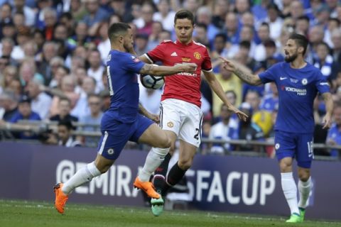 Chelsea's Eden Hazard, left, vies for the ball with Manchester United's Ander Herrera during the English FA Cup final soccer match between Chelsea and Manchester United at Wembley stadium in London, Saturday, May 19, 2018. (AP Photo/Tim Ireland)