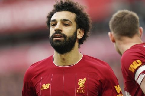 Liverpool's Mohamed Salah smiles during the English Premier League soccer match between Liverpool and Bournemouth at Anfield stadium in Liverpool, England, Saturday, March 7, 2020. (AP Photo/Jon Super)