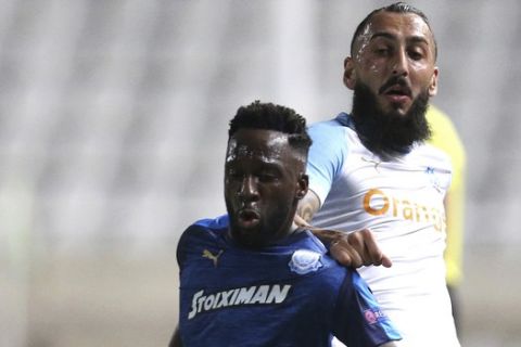 Apollon's Richard Soumah, left, fights for the ball with Marseille's Konstantinos Mitroglou during the Europa League group H soccer match between Apollon Limassol and Marseille at GSP stadium, in Nicosia, Cyprus, on Thursday, Oct. 4, 2018. (AP Photo/Petros Karadjias)