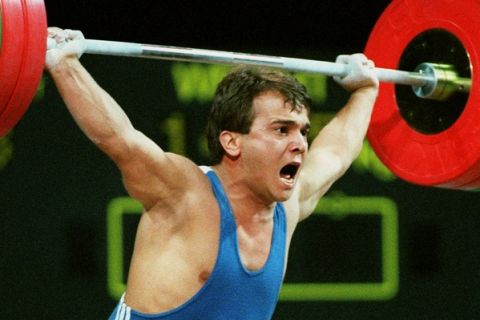 Naim Suleymanoglu, a Turkish hero known as Pocket Hercules, lifts 335kg Monday, July 22, 1996 at the Summer Olympics in Atlanta. Suleymanoglu became the first weightlifter in Olympic history to earn three gold medals.  (AP Photo/Michael Probst)