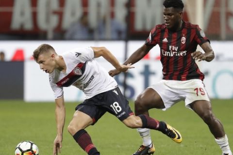 AC Milan's Franck Kessie, right, challenges for the ball with Cagliari's Nicolo' Barella during a Serie A soccer match between AC Milan and Cagliari, at the San Siro stadium in Milan, Italy, Sunday, Aug. 27, 2017. (AP Photo/Luca Bruno)