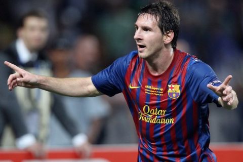 Barcelona's Argentinian midfielder Lionel Messi celebrates after scoring a goal during the UEFA Super Cup football match FC Barcelona vs FC Porto, on August 26, 2011 at the Louis II stadium in Monaco. AFP PHOTO VALERY HACHE (Photo credit should read VALERY HACHE/AFP/Getty Images)