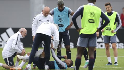 France's Kylian Mbappe grimaces after being injured during a training session at the 2018 soccer World Cup in Glebovets, Russia, Tuesday, June 12, 2018. (AP Photo/David Vincent)
