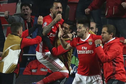 Benfica's Kostas Mitroglou celebrates with teammates scoring the opening goal during the Champions League round of 16, first leg, soccer match between Benfica and Borussia Dortmund at the Luz stadium in Lisbon, Tuesday, Feb. 14, 2017. (AP Photo/Armando Franca)