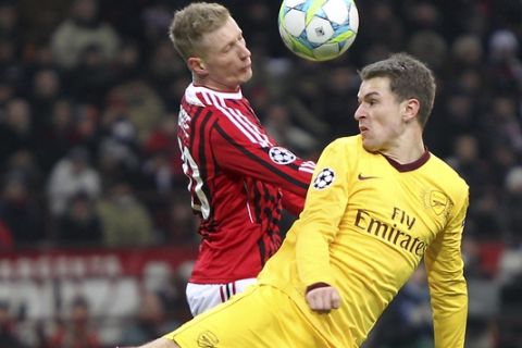 Arsenal midfielder Aaron Ramsey, right, of Wales, challenges for the ball with AC Milan midfielder Ignazio Abate during a Champions League, round of 16, first leg, soccer match between AC Milan and Arsenal at the San Siro stadium in Milan, Italy, Wednesday, Feb. 15, 2012. (AP Photo/Antonio Calanni)