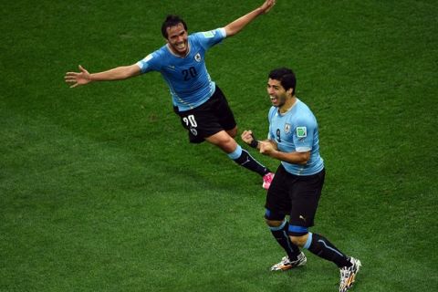 SAO PAULO, BRAZIL - JUNE 19:  Luis Suarez of Uruguay (R) celebrates scoring his team's first goal with Alvaro Gonzalez during the 2014 FIFA World Cup Brazil Group D match between Uruguay and England at Arena de Sao Paulo on June 19, 2014 in Sao Paulo, Brazil.  (Photo by Matthias Hangst/Getty Images)