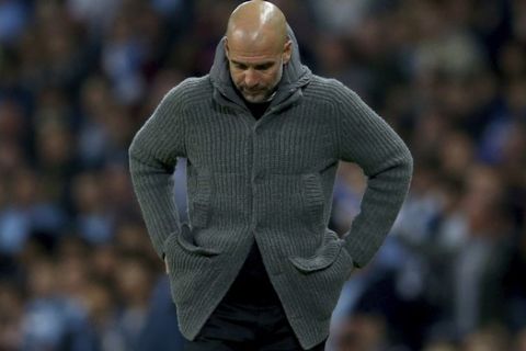 Manchester City coach Pep Guardiola looks down during the Champions League quarterfinal, second leg, soccer match between Manchester City and Tottenham Hotspur at the Etihad Stadium in Manchester, England, Wednesday, April 17, 2019. (AP Photo/Dave Thompson)