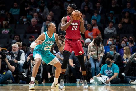 Charlotte Hornets forward P.J. Washington (25) defends Miami Heat forward Jimmy Butler (22) during the first half of an NBA basketball game, Thursday, Feb. 17, 2022, in Charlotte, N.C. (AP Photo/Matt Kelley)