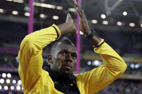 Jamaica's Usain Bolt bids farewell during a lap of honor at the end of the World Athletics Championships in London Sunday, Aug. 13, 2017. (AP Photo/Matthias Schrader)