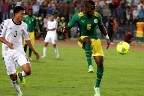 Egypt's, Mahmoud Hassan, aka "Trezygait," left, and Senegal's Souleymane Diawara compete for the ball during their African Cup of Nations group G qualifying soccer match at  Cairo International Stadium in Cairo, Egypt, Saturday, Nov. 15, 2014. The other two teams in group G are Tunisia and Botswana. (AP Photo/Ahmed Gamil)