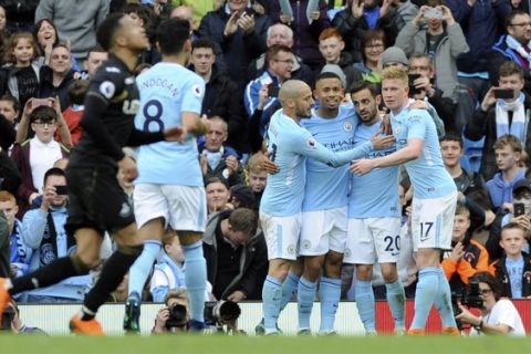 Manchester City's Bernardo Silva, 2nd right, celebrates with teammates after scoring his side's fourth goal during the English Premier League soccer match between Manchester City and Swansea City at Etihad stadium in Manchester, England, Sunday, April 22, 2018. (AP Photo/Rui Vieira)