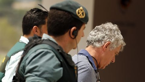 Former President of the Spanish Football Federation Angel Maria Villar, right, is lead by Spanish Civil Guard policeman to enter the Federation headquarters during an anti-corruption operation in Las Rozas, outside Madrid, Tuesday, July 18, 2017.  Villar, FIFA's senior vice president and a long-time player in world soccer, was arrested Tuesday along with his son and two more federation executives in an anti-corruption investigation. (AP Photo/Francisco Seco)